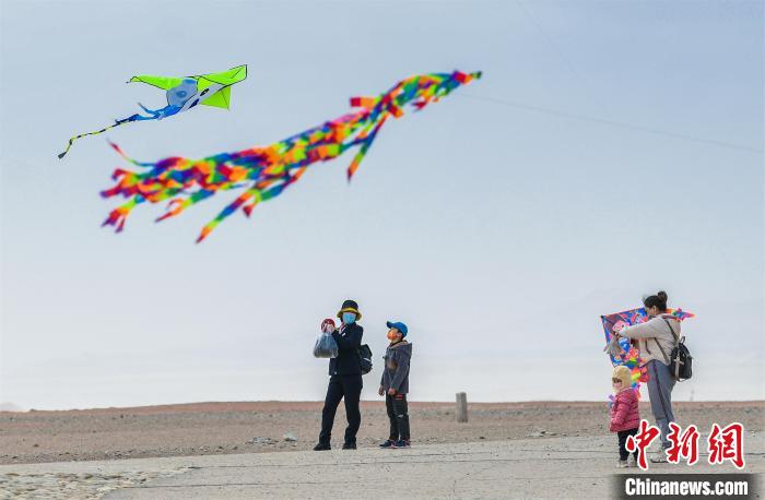 圖為孩童在父母的陪伴下放風(fēng)箏。　王斌銀 攝